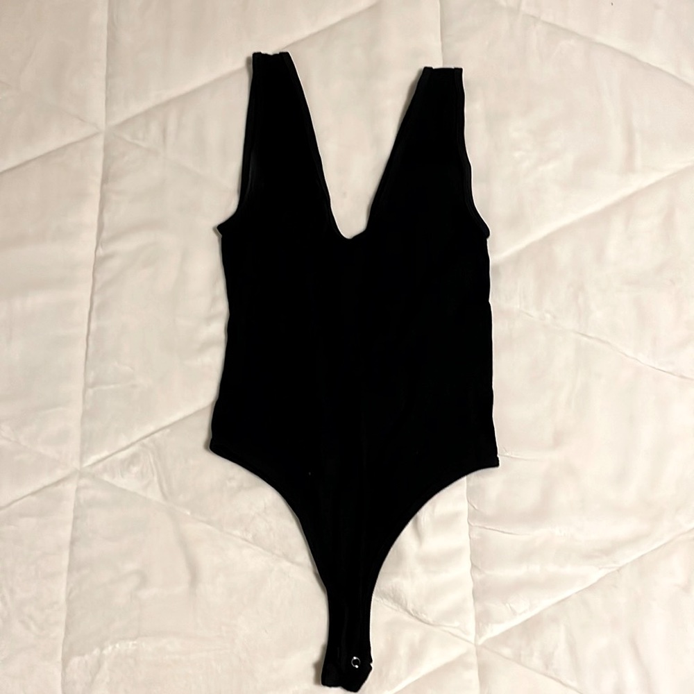 Size small/medium. Black low cut bodysuit.